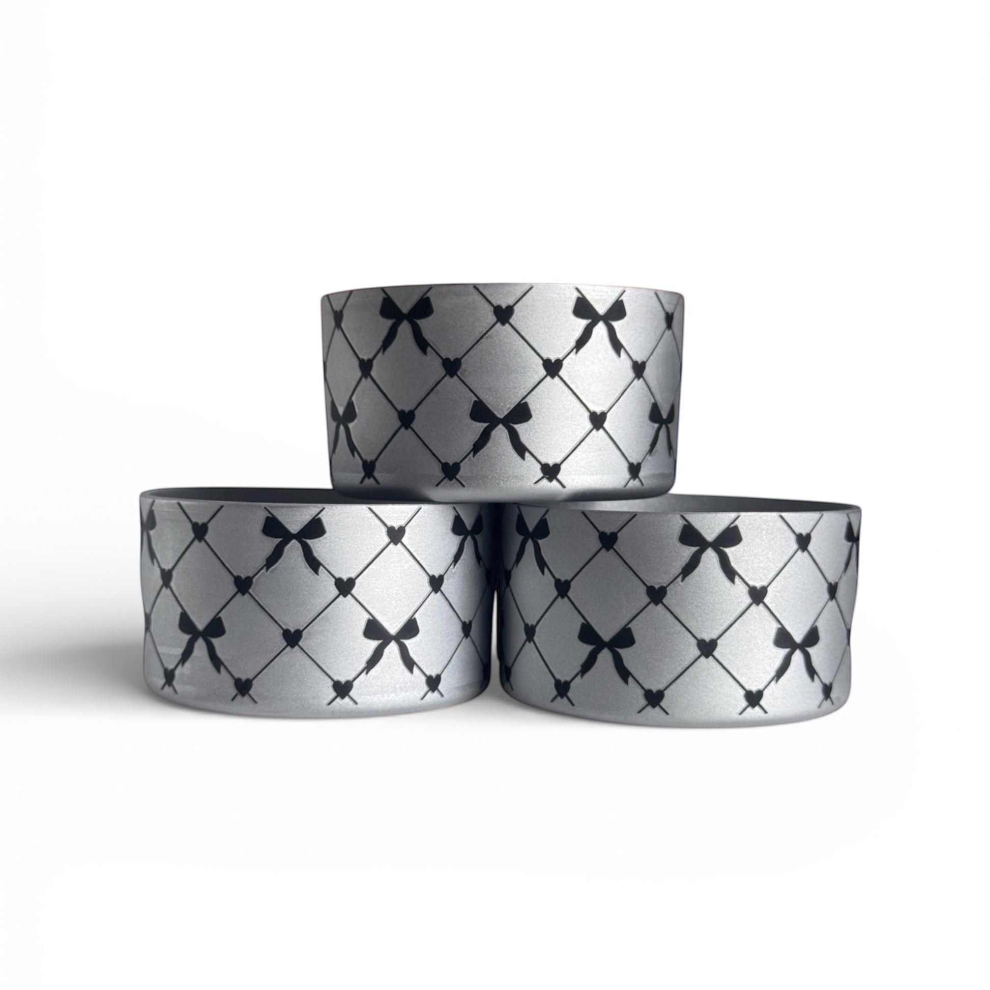 Next Nirvana silver silicone tumbler boot with black criss-cross bow and heart pattern for Stanley and other tumblers.
