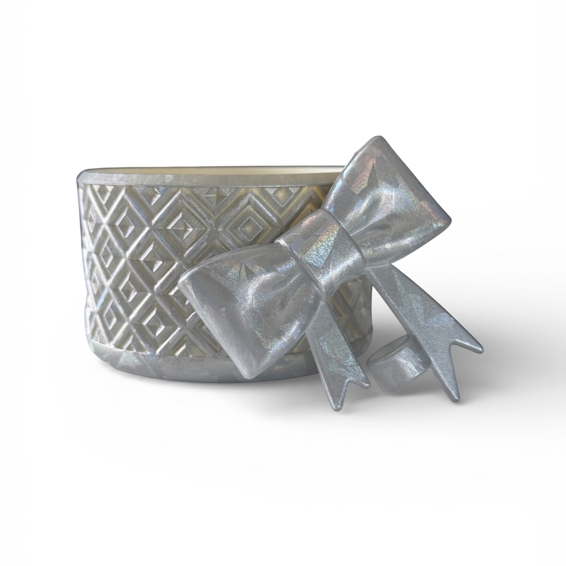 Next Nirvana silver diamond-pattern silicone tumbler boot with a matching 3D bow straw topper on a white background.