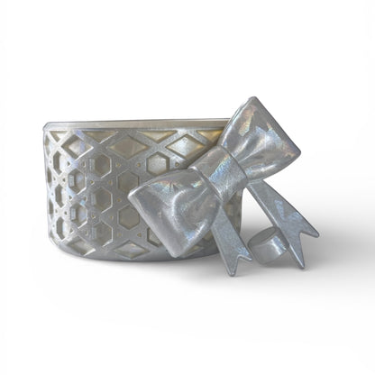 Next Nirvana silver silicone tumbler boot and matching 3D bow straw topper with a textured waffle pattern