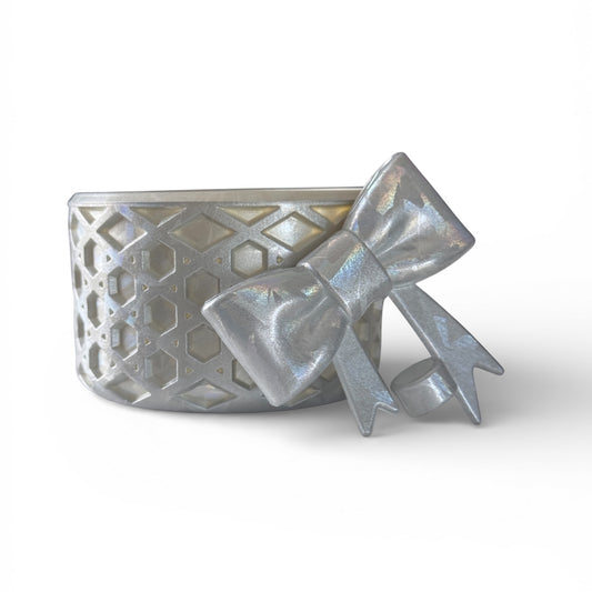 Next Nirvana silver silicone tumbler boot and matching 3D bow straw topper with a textured waffle pattern