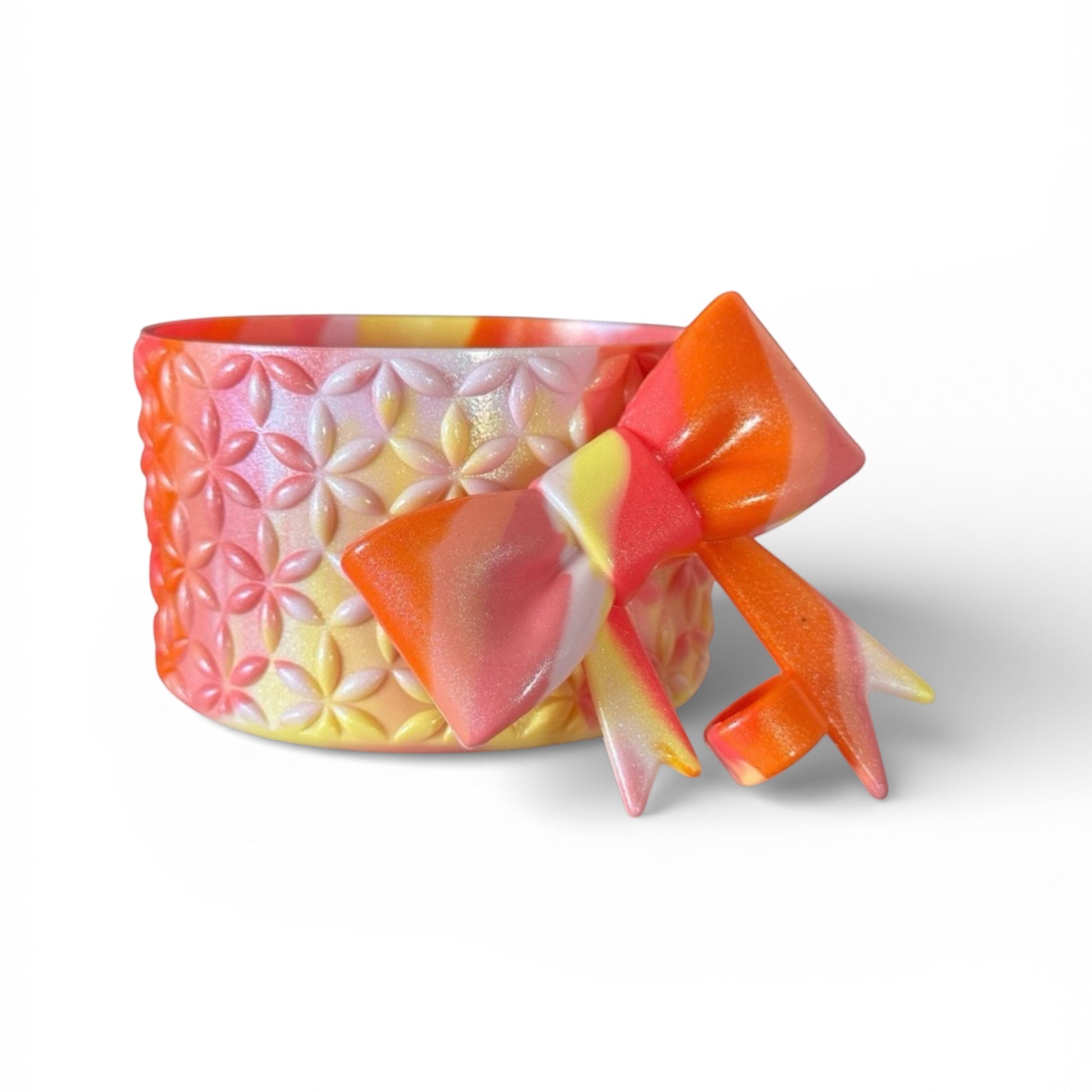 Next Nirvana Summer Heat Shimmer silicone tumbler boot and matching 3D bow straw topper in pink, orange, and yellow.