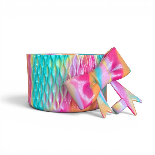 Next Nirvana Summer Splash shimmer silicone tumbler boot and matching 3D bow straw topper in a vibrant rainbow swirl.