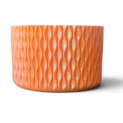 Next Nirvana tangerine shimmer silicone tumbler boot with a 3D textured wave pattern for 20-40oz drinkware protection.