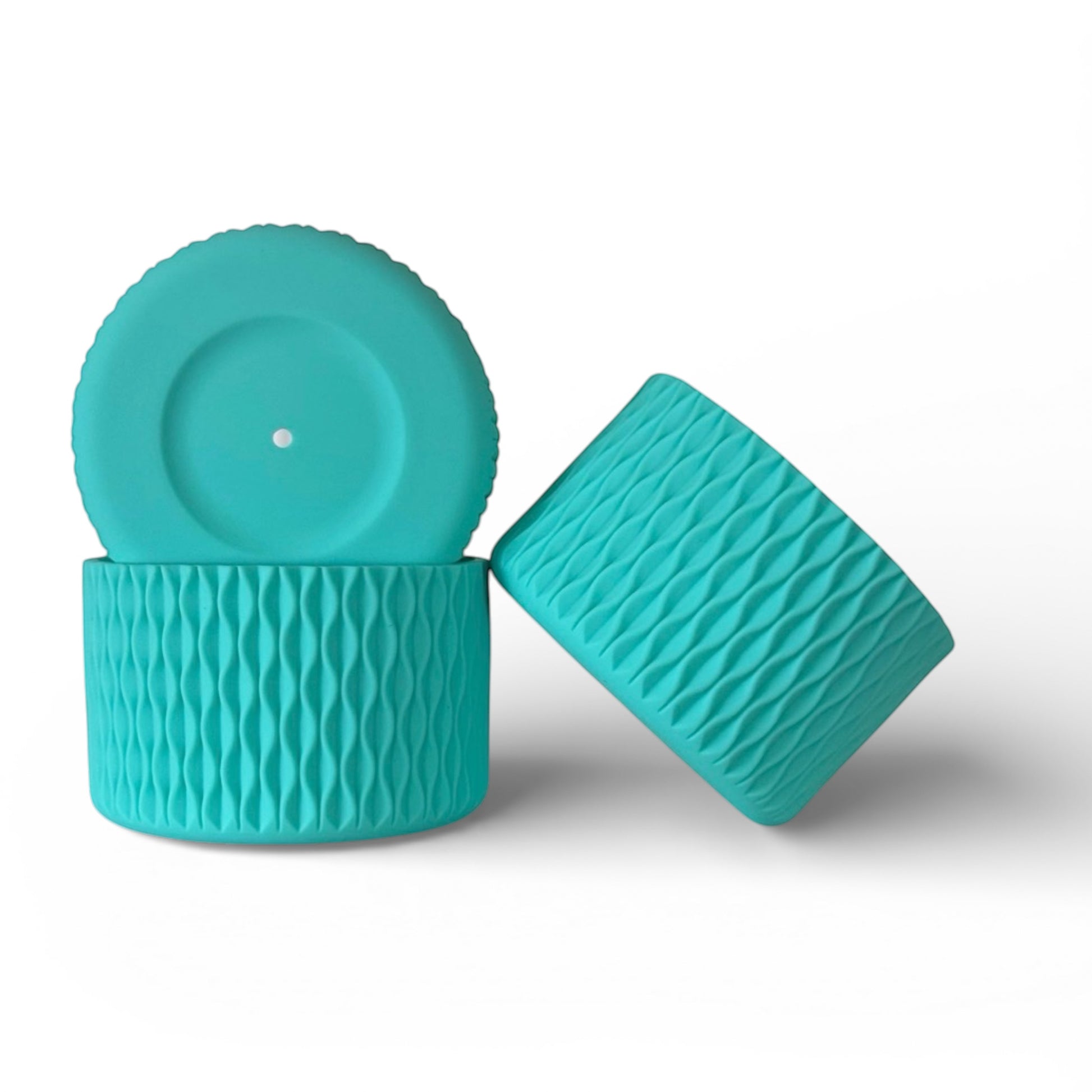 Next Nirvana teal silicone tumbler boot with textured waves pattern for protective non-slip base on water bottles