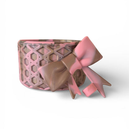Next Nirvana antique pink and champagne waffle-textured silicone tumbler boot with a matching 3D bow straw topper.