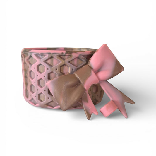 Next Nirvana antique pink and champagne waffle-textured silicone tumbler boot with a matching 3D bow straw topper.