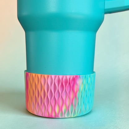 Next Nirvana silicone tumbler boot with a 3D wave texture in a vibrant pink, orange, and yellow tie-dye pattern.